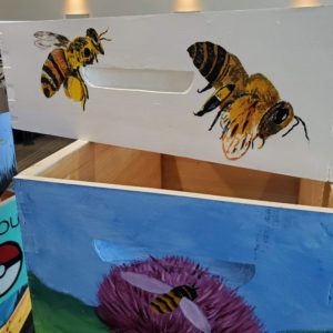 Bees painted on boxes for bee hives