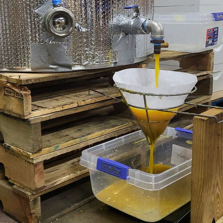 Melting beeswax from wax tank and filtering it